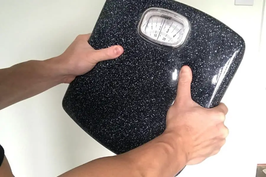 Use a body scale to measure grip strength.
