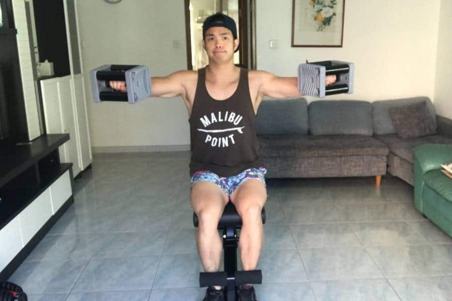 Seated lateral raise with Powerblock dumbbells.