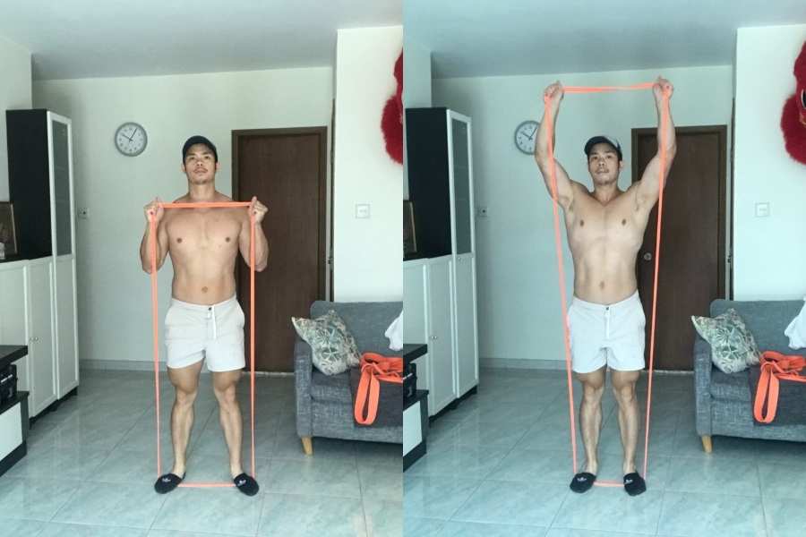Picture of how to do the overhead press using resistance bands.