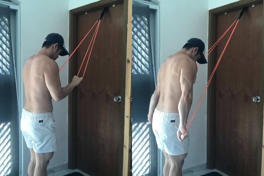 Picture of how to do the tricep pull down using resistance bands.