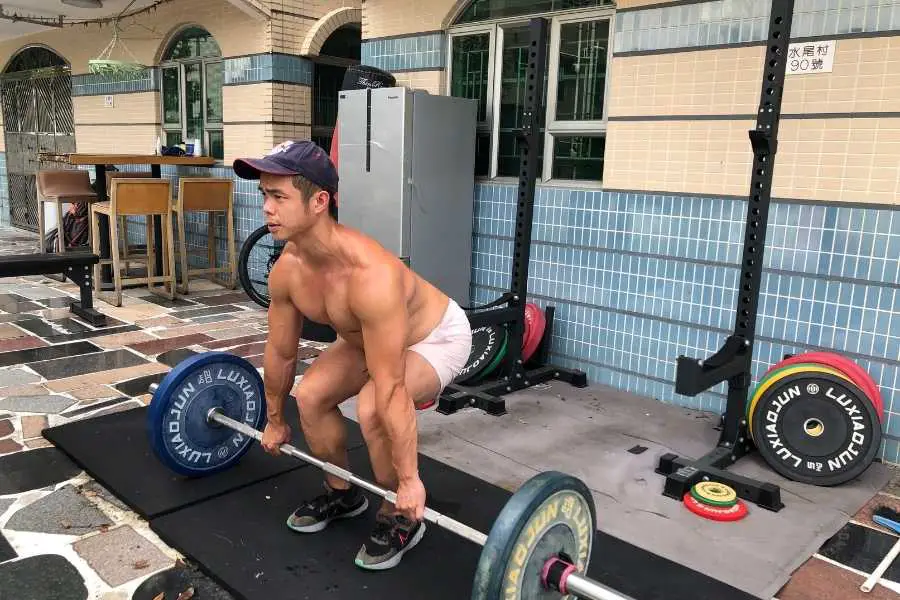 Heavy deadlifting to build full-body muscle and get buff.